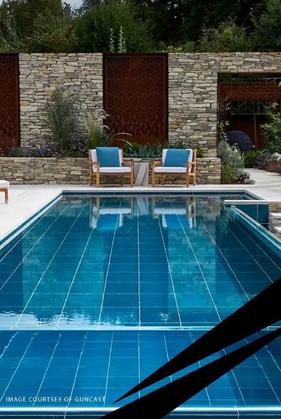 Terraced swimming pool and sunbeds surrounded by a distinctive stone wall.