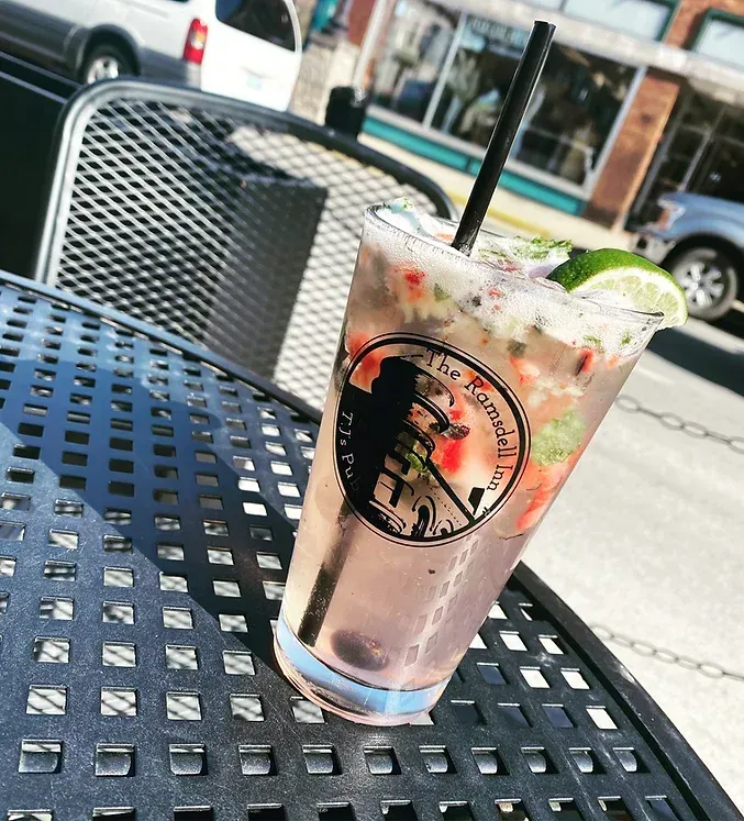 A drink in a glass with a straw on a table