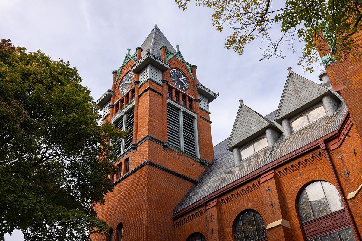 A large brick building with a clock tower on top of it.