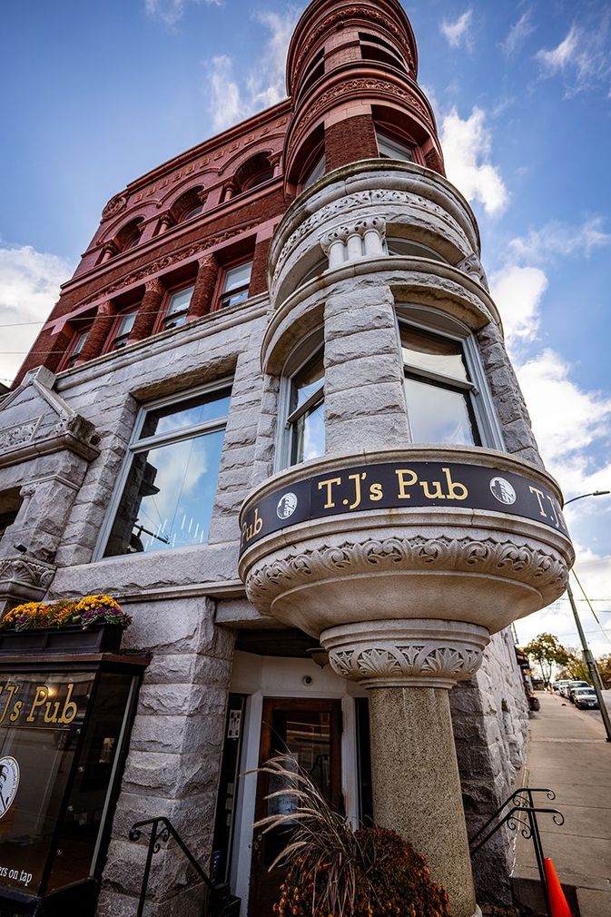 A large brick building with a sign that says t.j. 's pub on it.