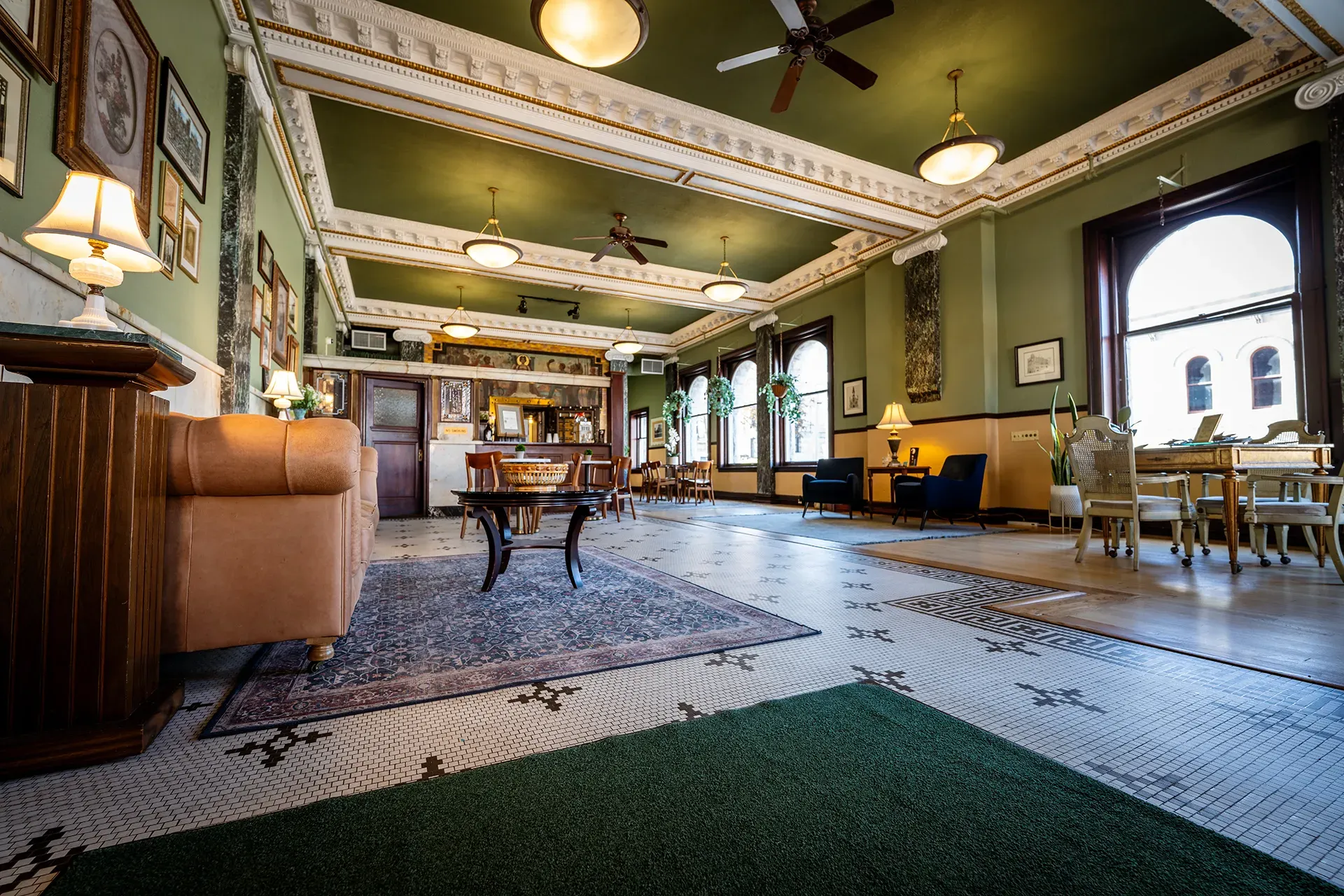 A large room with a lot of furniture and a green ceiling.