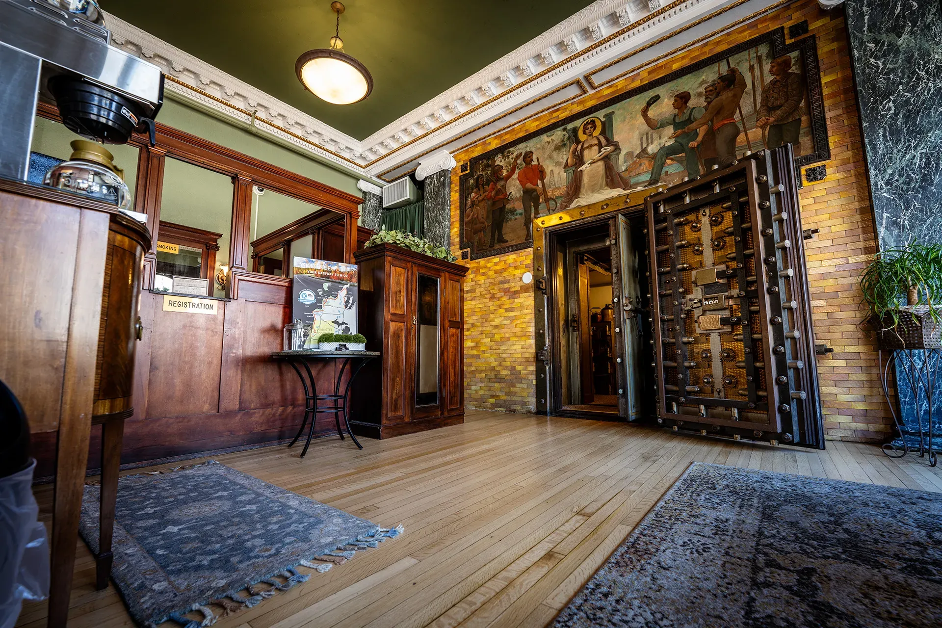 A large room with a vaulted door and a painting on the wall.