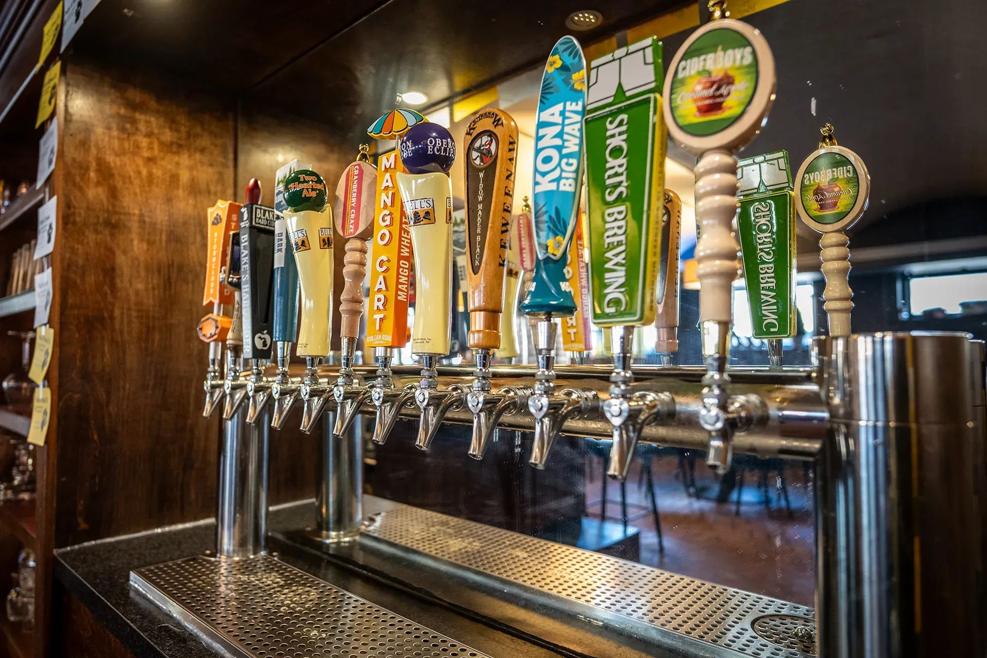 A bar with a bunch of beer taps on it