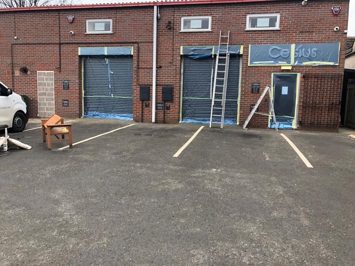 This is a picture of the outside of a factory building in Hinckley showing the shutter doors had been painted in an industrial grey colour to match the main back door entrance. By painter and decorator Leicester