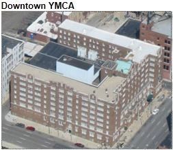 Aerial view of a brown brick Downtown YMCA building with multiple floors and a flat roof.
