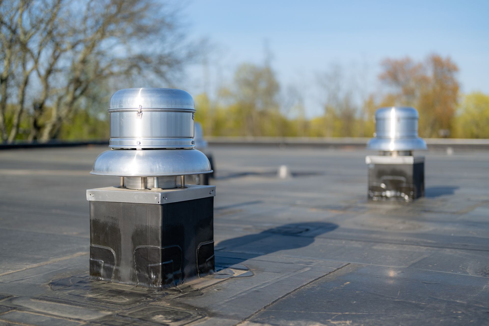 Ventilation units installed on a flat membrane roof.