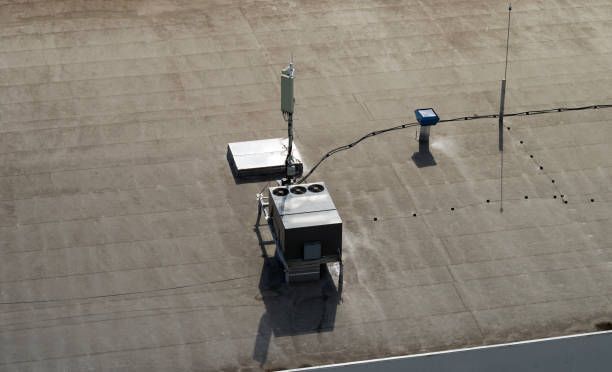 Business Roof Repair on commercial building with AC units, cellular antenna, and lightning rod