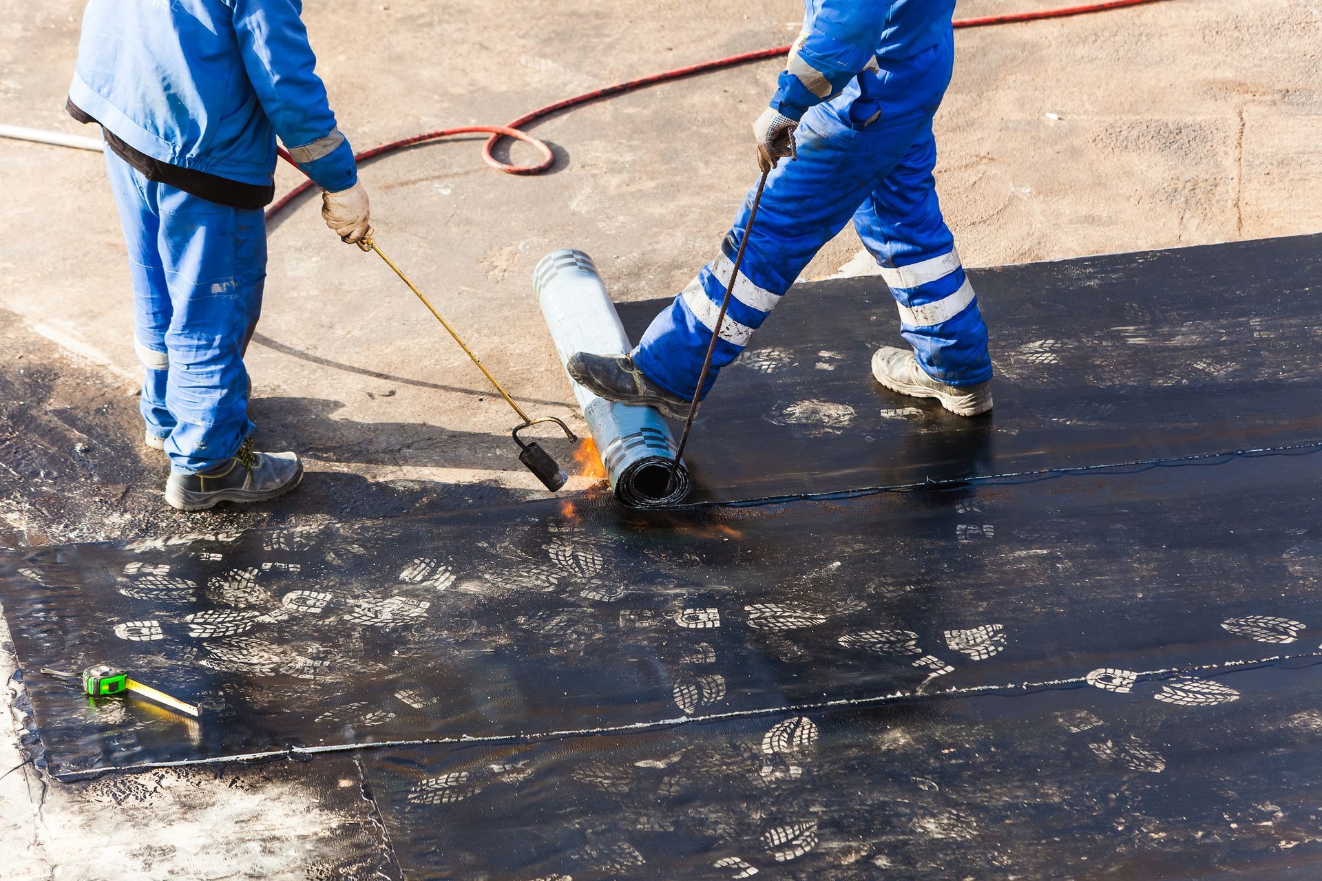 Professional roofers from Allied Roofing installing a durable modified bitumen roof on a commercial property in Columbus, OH. Professional roofers from Allied Roofing installing a durable modified bitumen roof on a commercial property in Columbus, OH.