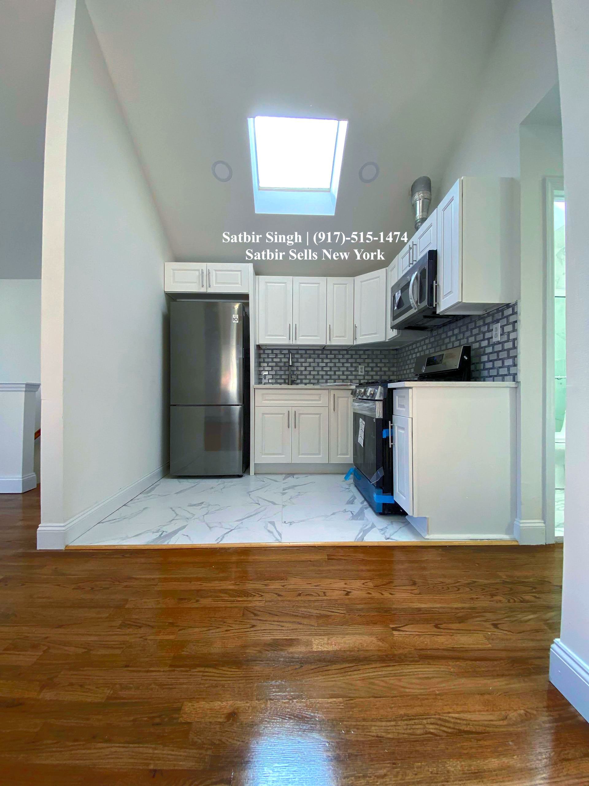 renovated kitchen along with a new home for sale call satbir singh 917-515-1474