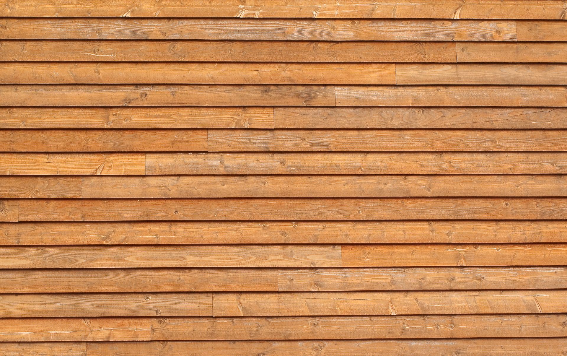 Close-up of horizontal wooden slats with a warm orange-brown finish.