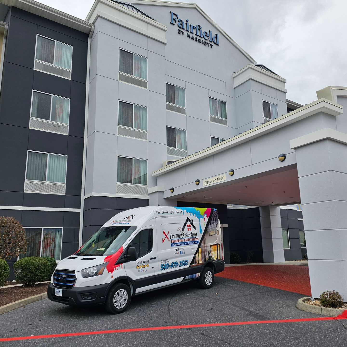 Hotel exterior with a van outside.
