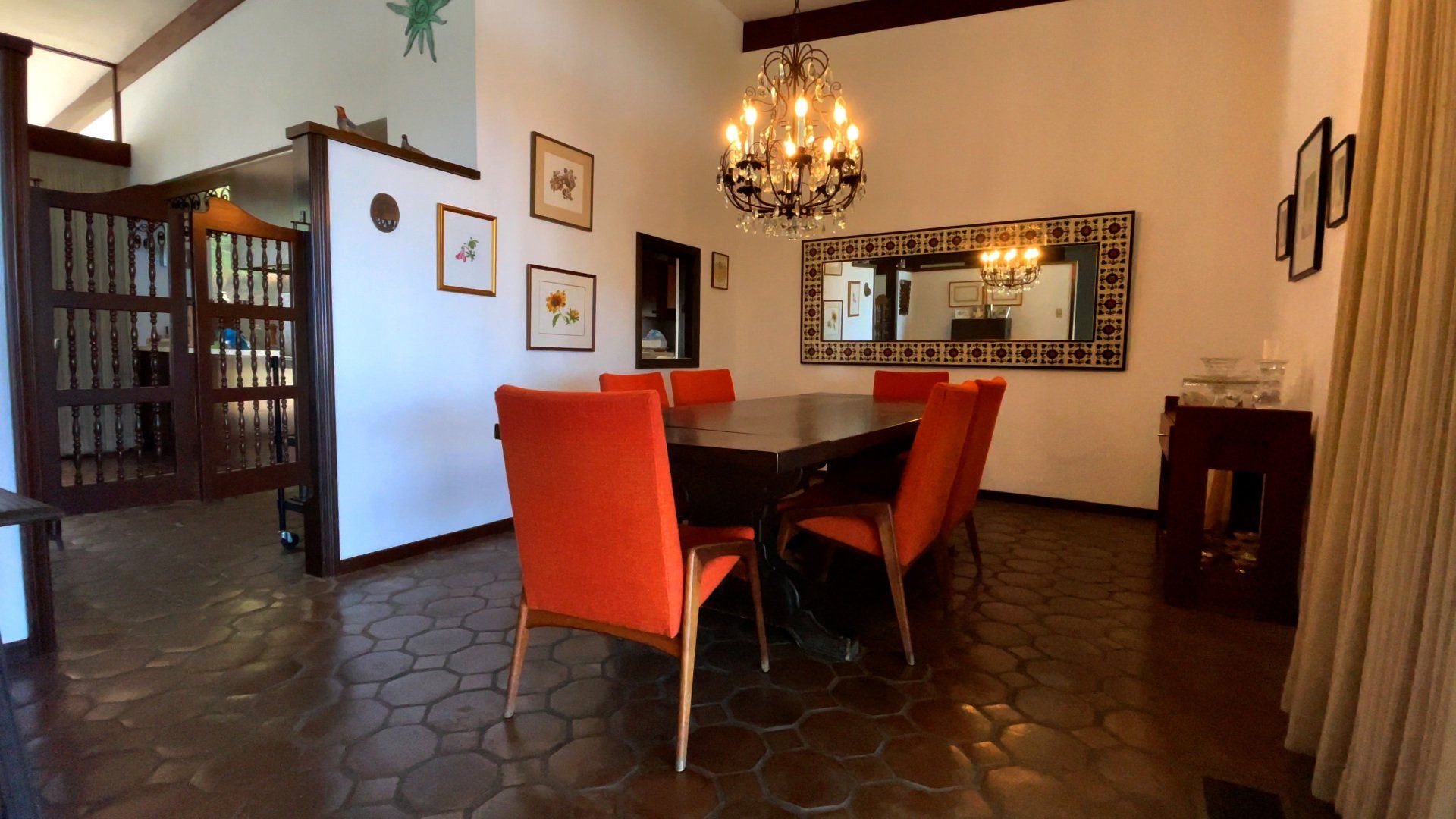 A dining room with a table and chairs and a chandelier
