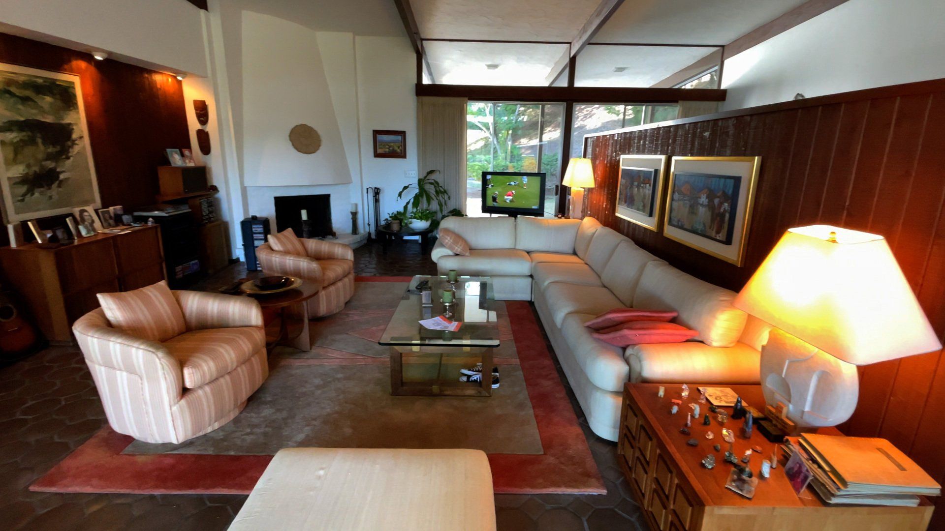 A living room with a large sectional couch and chairs