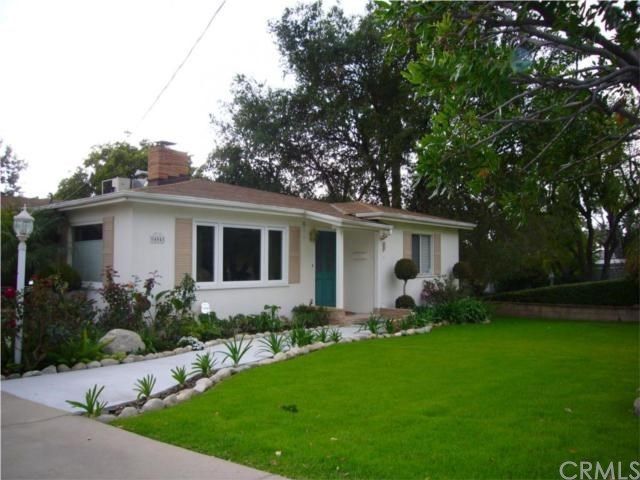 A white house with a green door is for sale by crmls