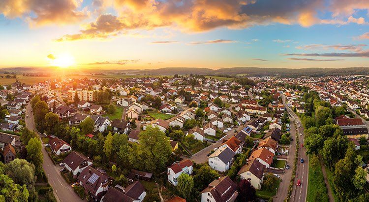 An aerial view of a small town at sunset.