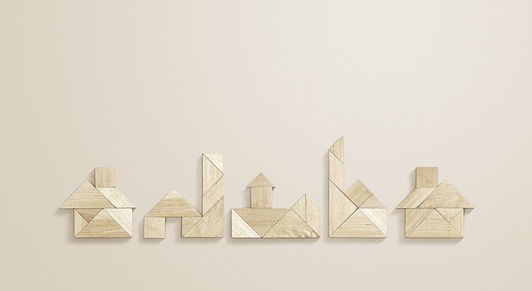 A tangram puzzle made of wooden blocks on a white wall.