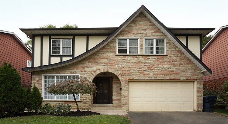 A large brick house with a white garage door