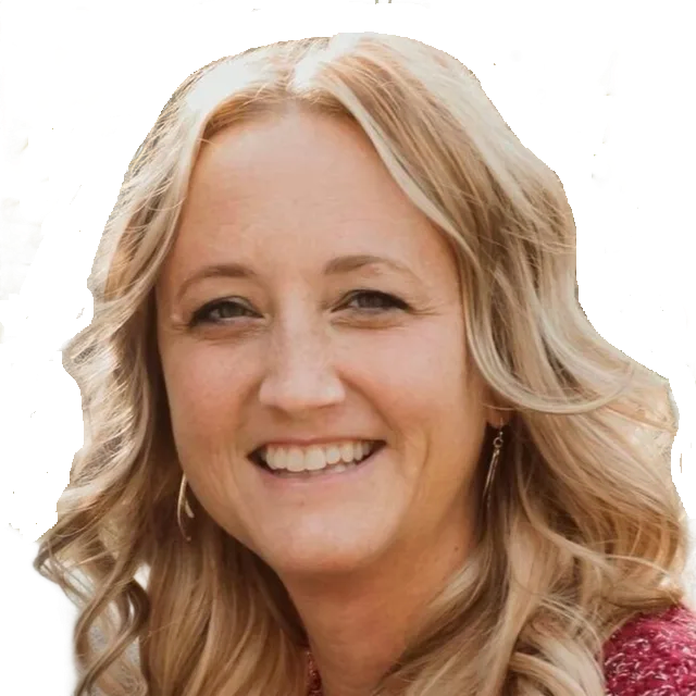 Close-up portrait of a smiling woman with blonde wavy hair on a white background