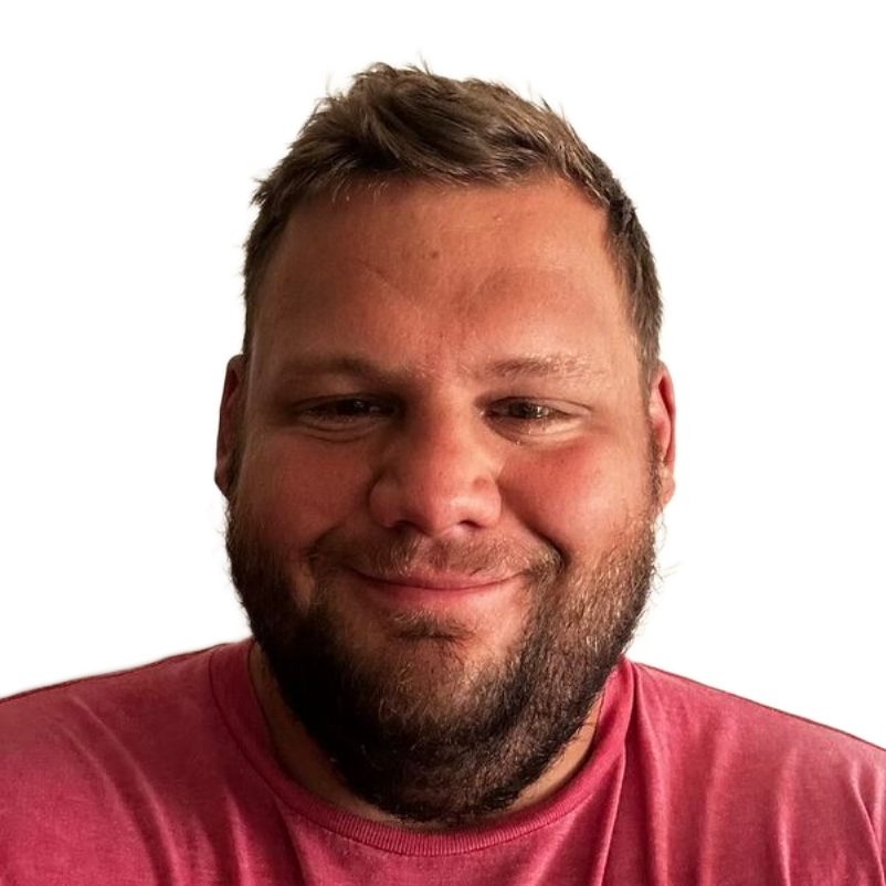 Close-up portrait of a smiling man in a pink shirt against a white background