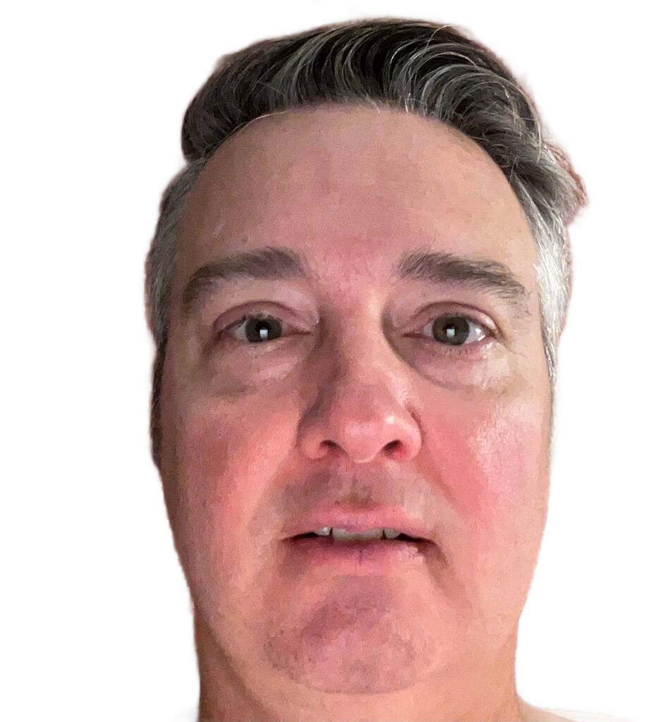 Close-up portrait of a man with short dark hair against a white background, looking at the camera.