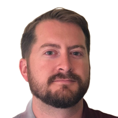Portrait of a bearded man with short dark hair against a white background