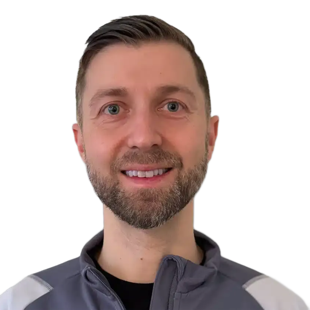 Smiling person in a gray jacket against a white background
