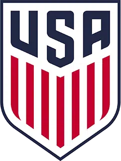 USA Soccer shield logo in navy, red, and white with vertical stripes and “USA” at top