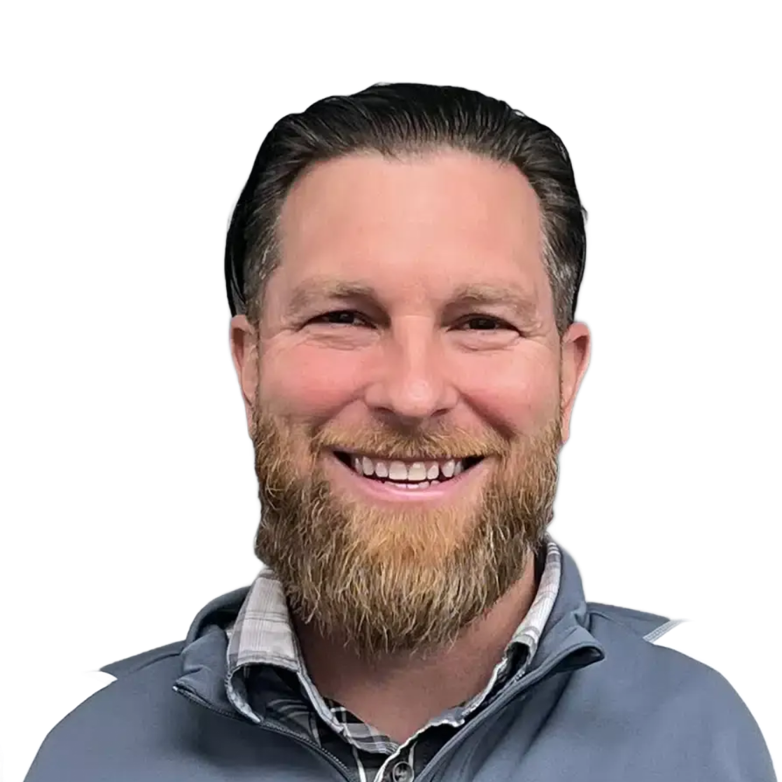 Smiling bearded man in a gray shirt against a white background