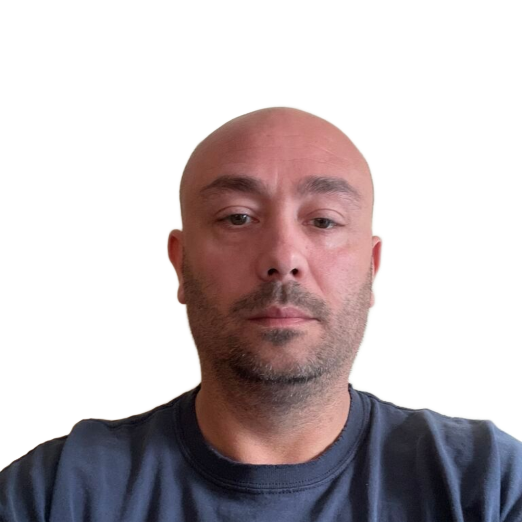 A bald man with a neutral expression against a plain white background