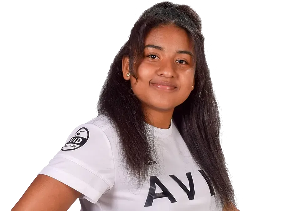 Smiling person in a white shirt with dark lettering, standing against a white background.