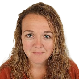 Close-up portrait of a woman with wavy hair wearing an orange top on a white background