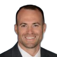 Headshot of a smiling man in a dark suit on a white background