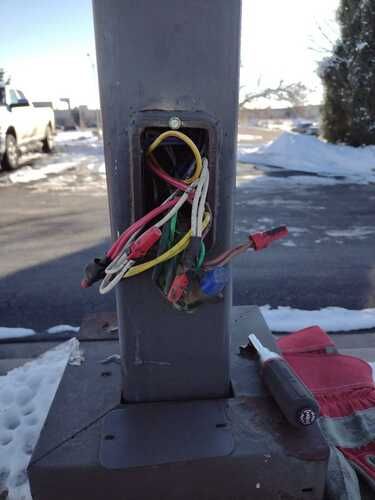 A pole with a bunch of wires sticking out of it.