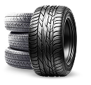 Stack of black car tires, with one tire standing upright in front. | Pacific Motor Service