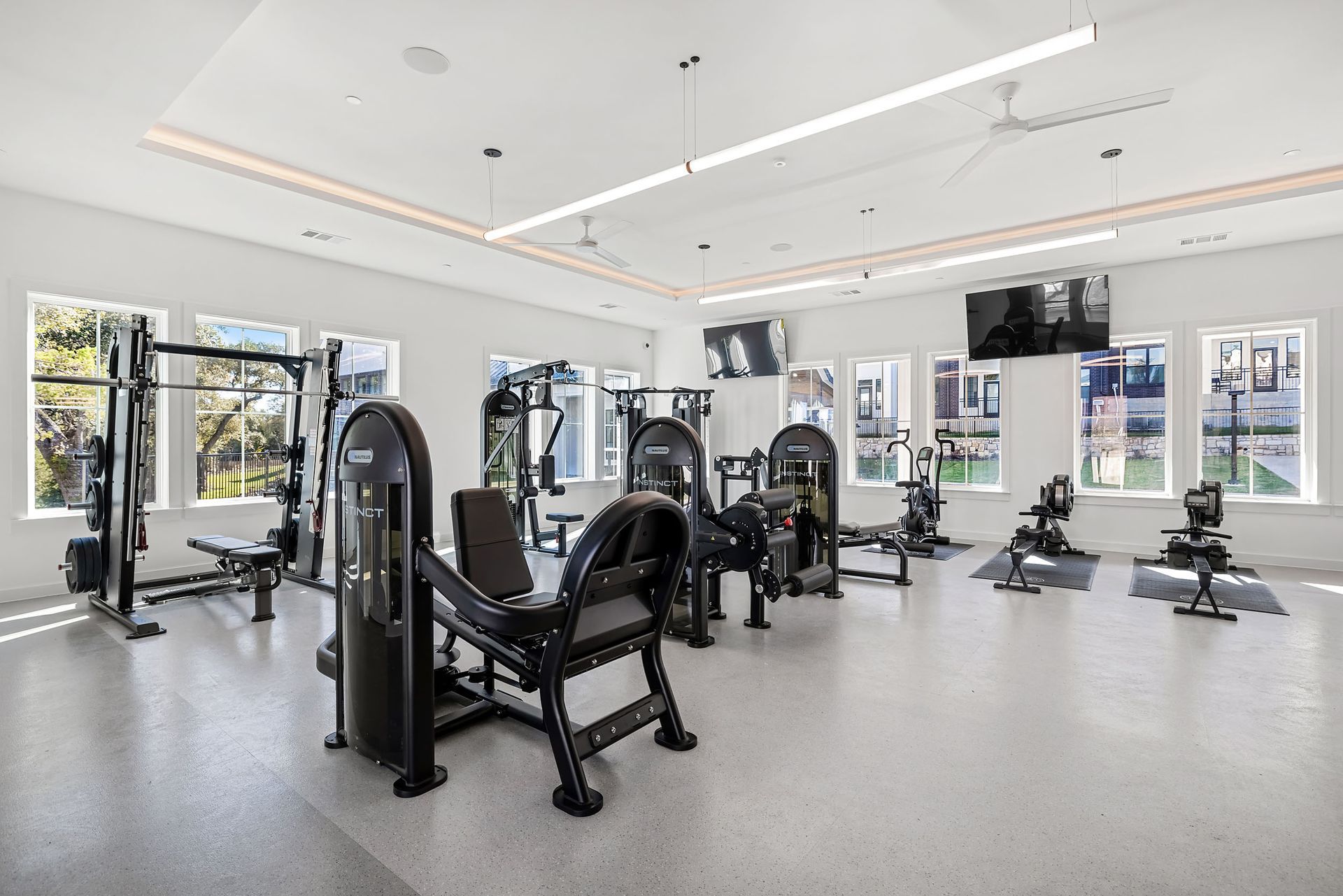 A large gym filled with lots of exercise equipment and a television at The Everett. offering apartments in Northwest Austin, TX.