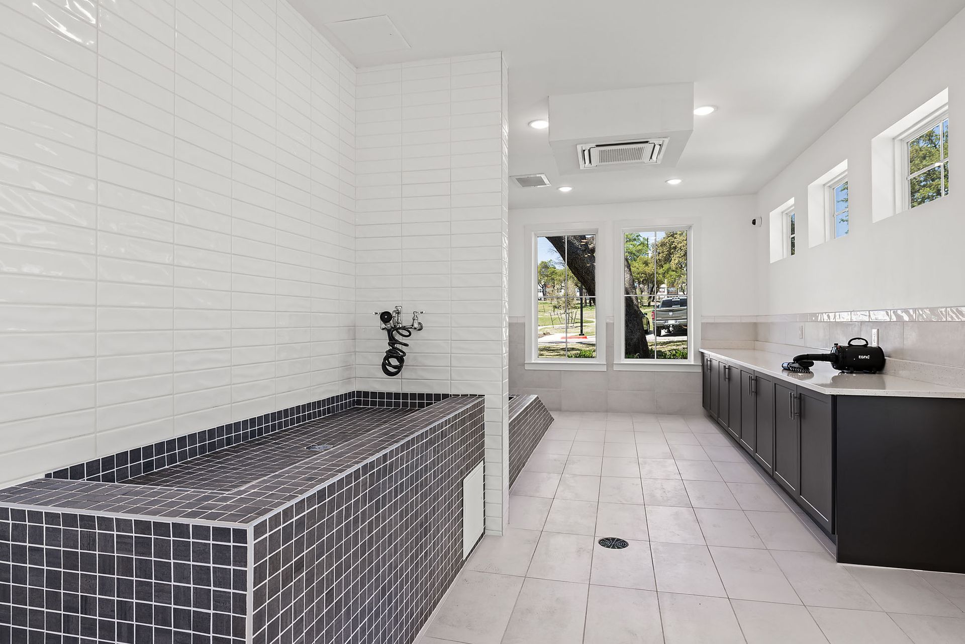 Pet wash room with a black and white tiled tub at The Everett, offering pet-friendly apartments for rent near The Domain in Austin, TX.