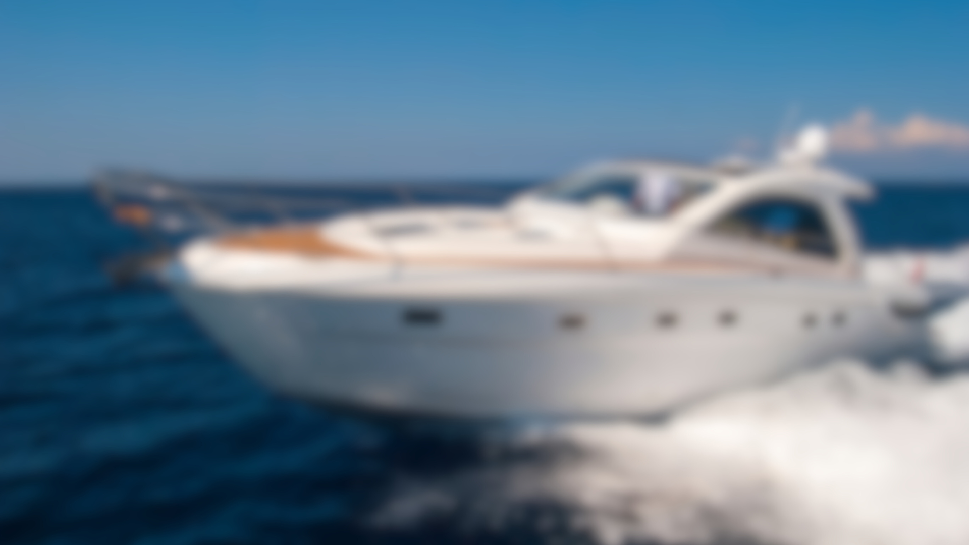A white boat is floating on top of a body of water.