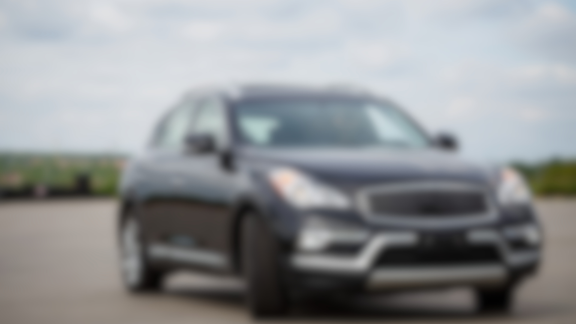 A blurred image of a car driving down a road.