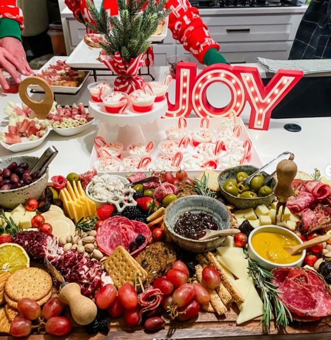 A table topped with lots of food and a sign that says joy