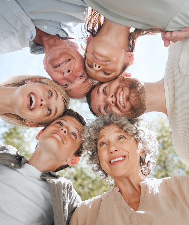 A group of people are standing in a circle looking up at the sky.