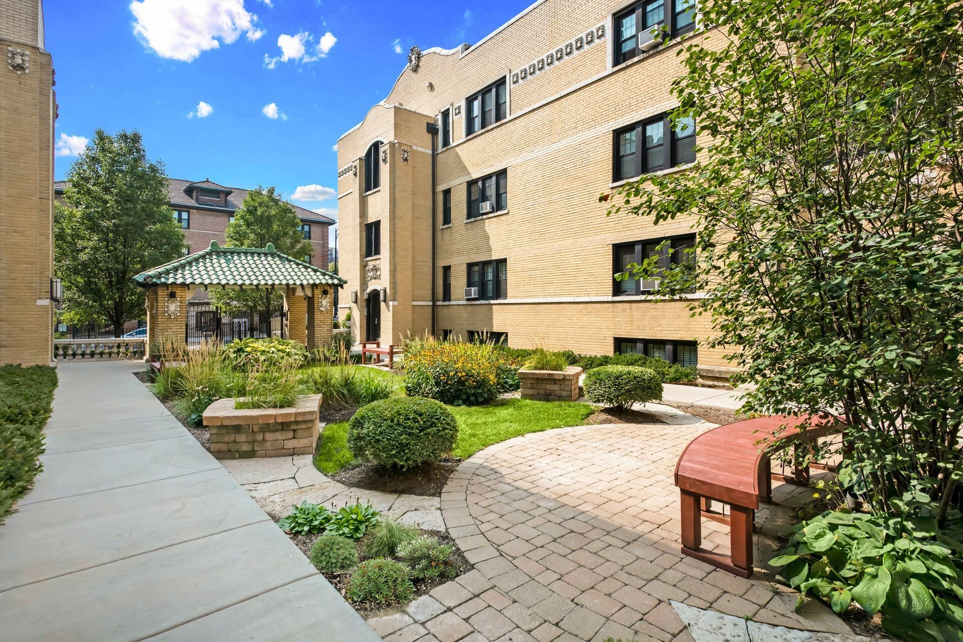 a brick building with a garden outside of it