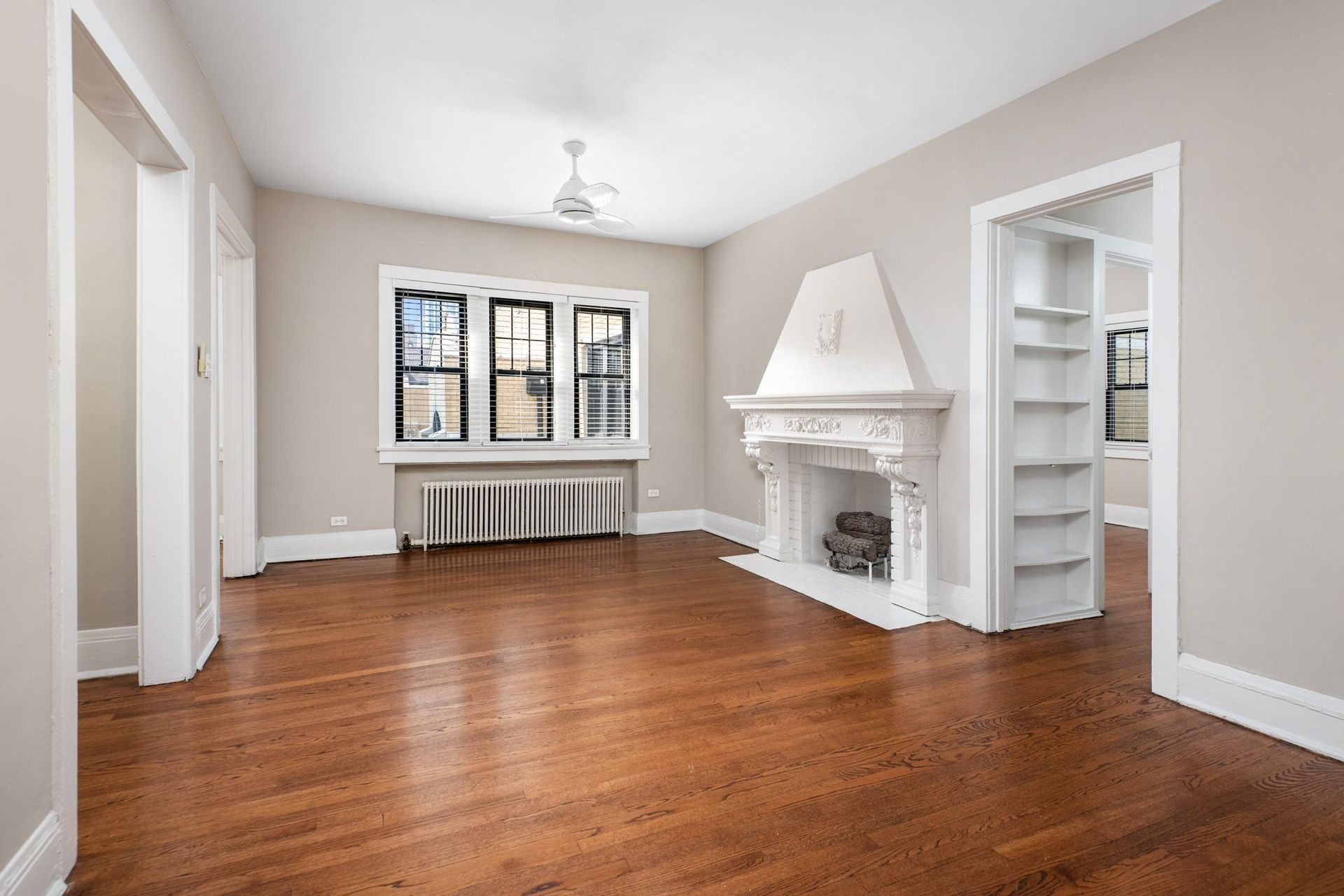 a living room with a fireplace and a book shelf