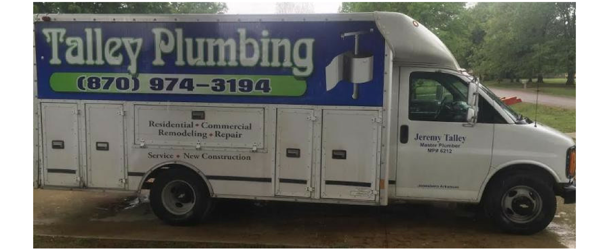 Talley Plumbing service van parked outdoors, white truck with blue signage and phone number.