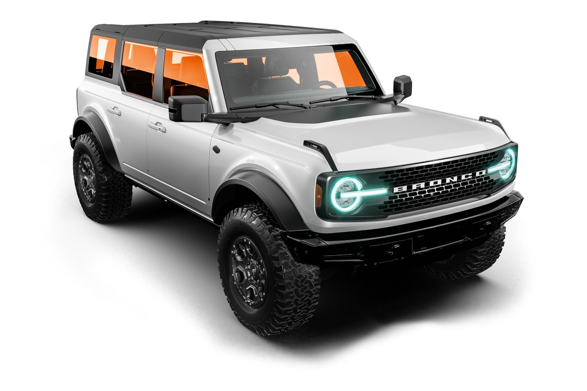 Silver off-road SUV with black trim and glowing teal headlights on a white background