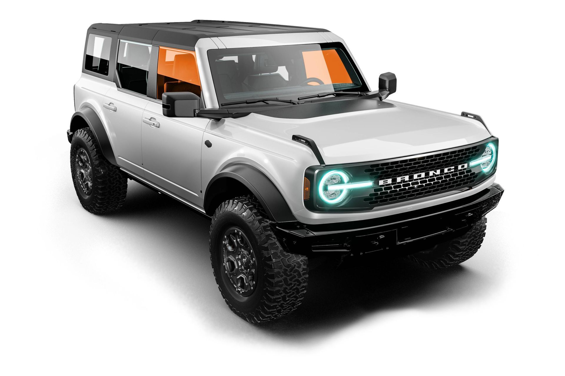 Silver off-road SUV with black roof, glowing headlights, and rugged tires on a white background