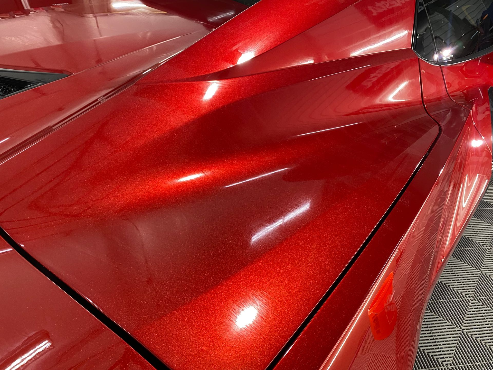 A close up of the hood of a red car