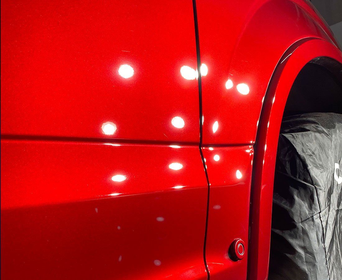 A close up of the side of a red car