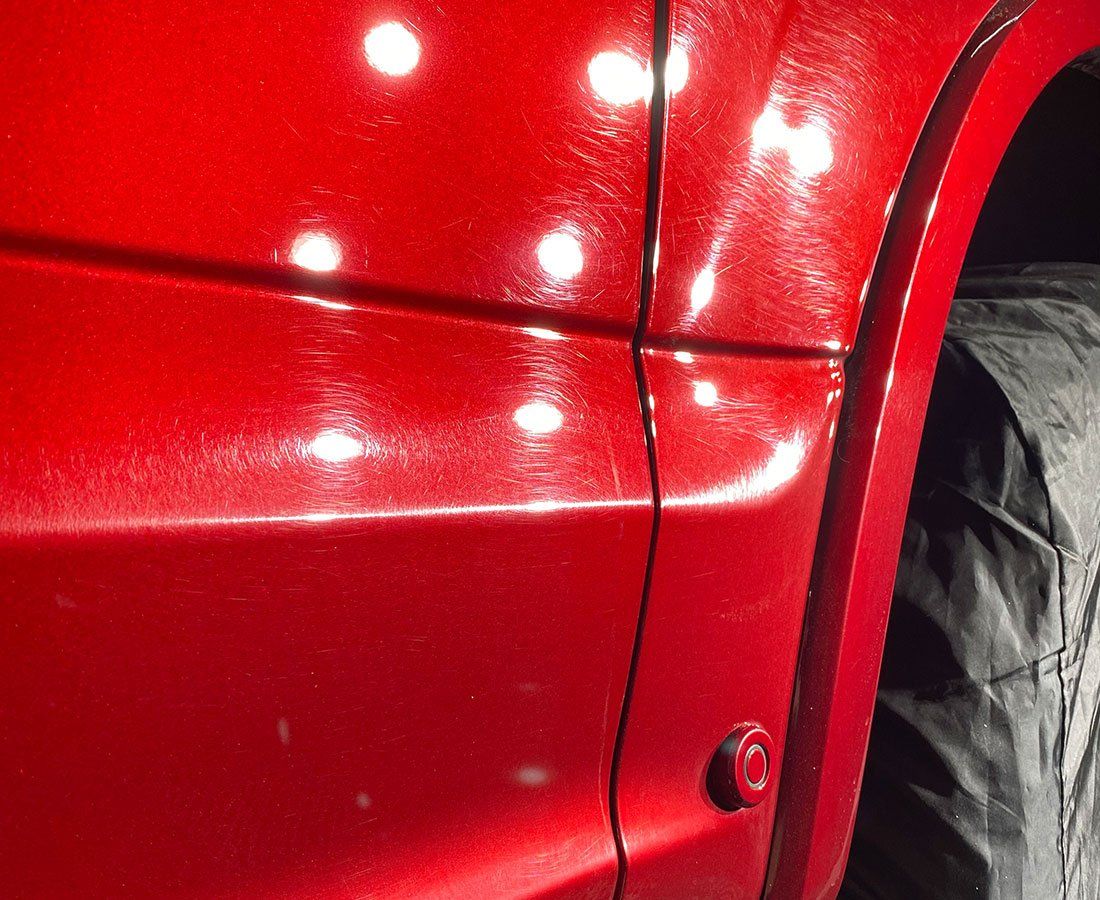 A close up of the side of a red car