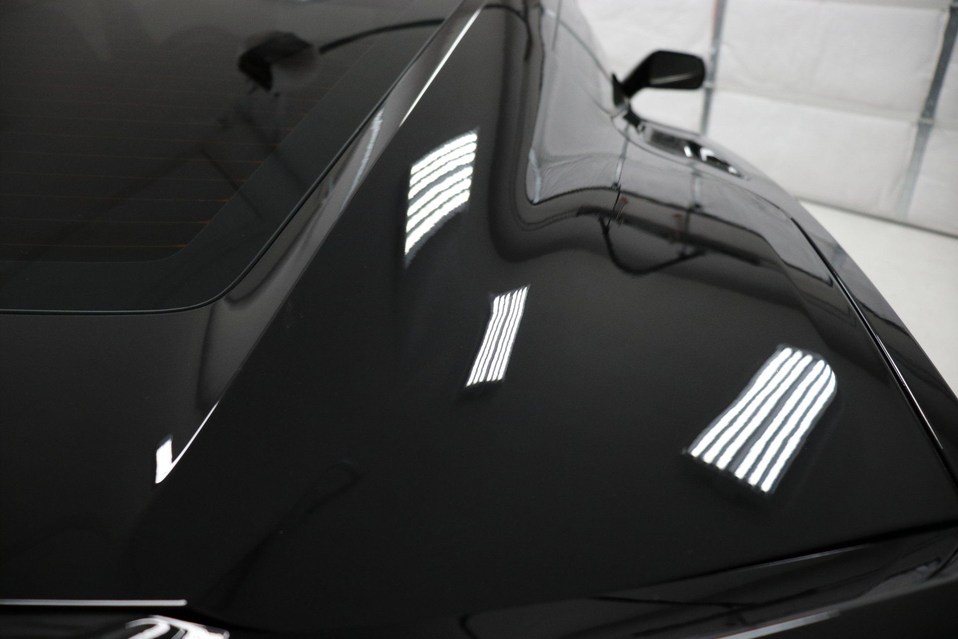 A close up of the hood of a black car