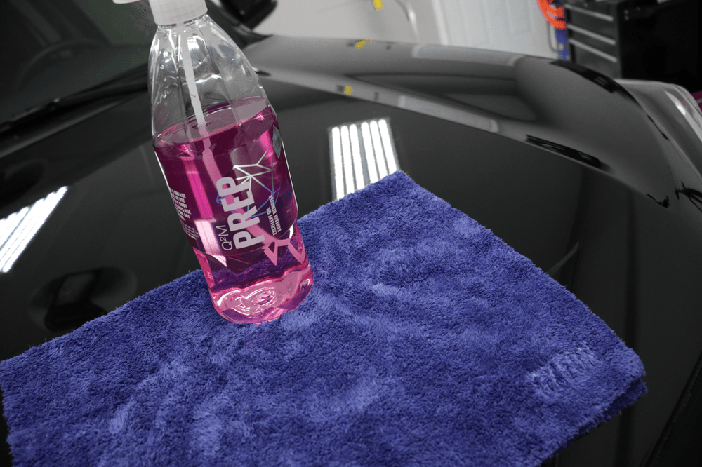 A bottle of prep is sitting on top of a blue towel.